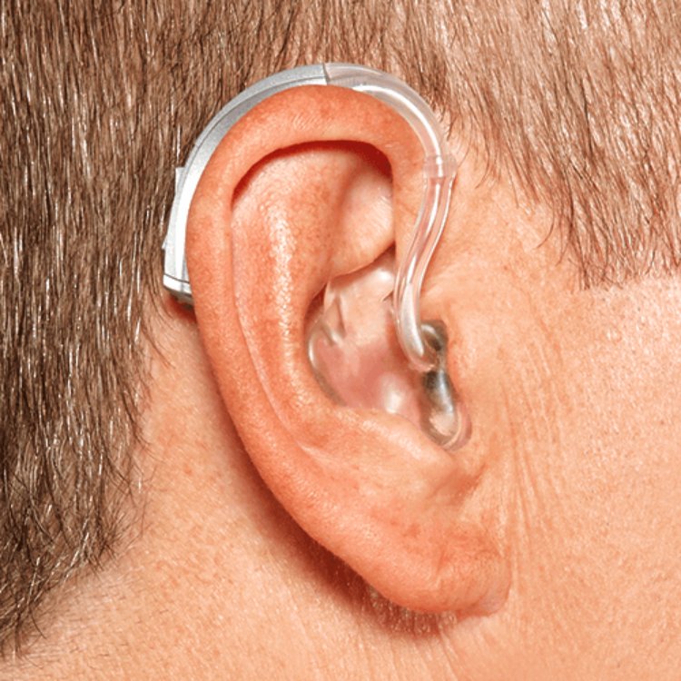 A behind-the-ear hearing aid, with the full body of the hearing aid sitting behind the ear and a soft tube leading forward