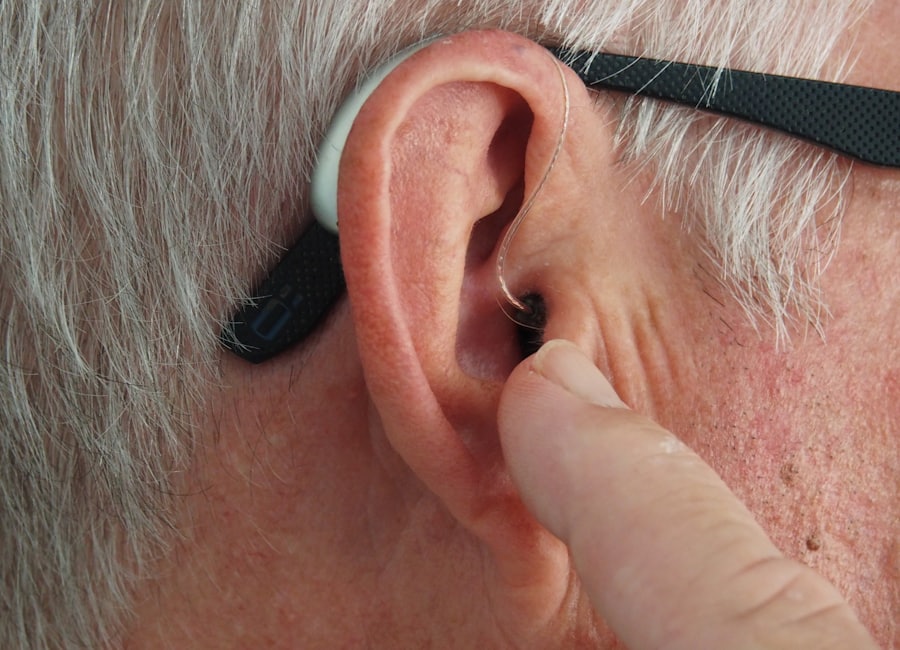 A behind-the-ear hearing aid being serviced